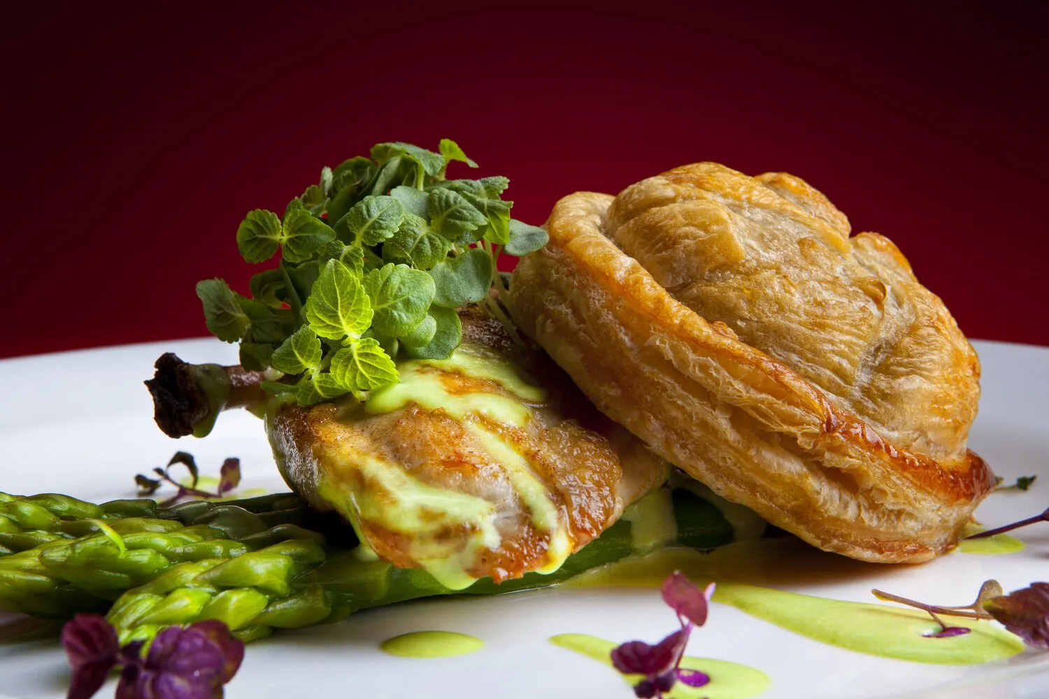 Breast of black leg chicken,confit leg pithiver, white asparagus & pea veloute