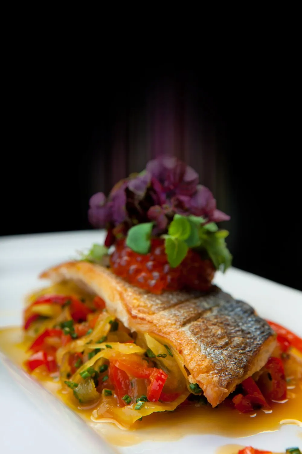 Seared fillet of sea bass with braised peppers and onion basquaise